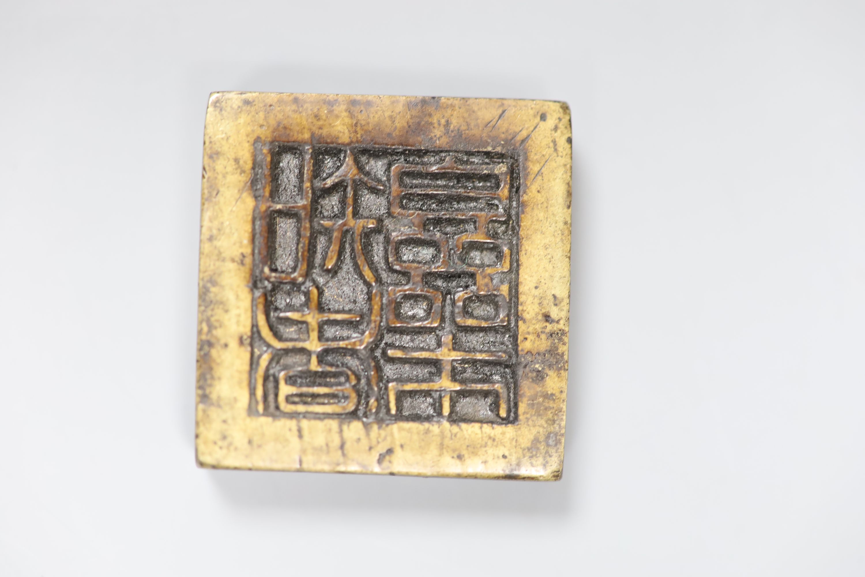 A group of Chinese bronze seals and a white metal elephant